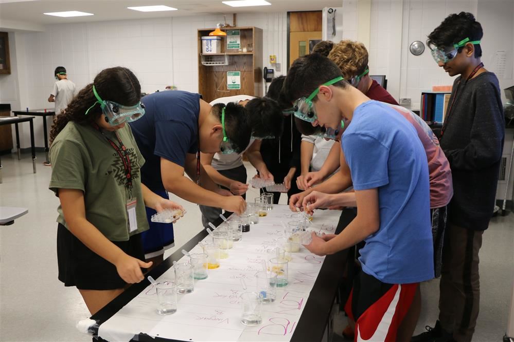 Students working together on a science experiment Students working together on a science experiment